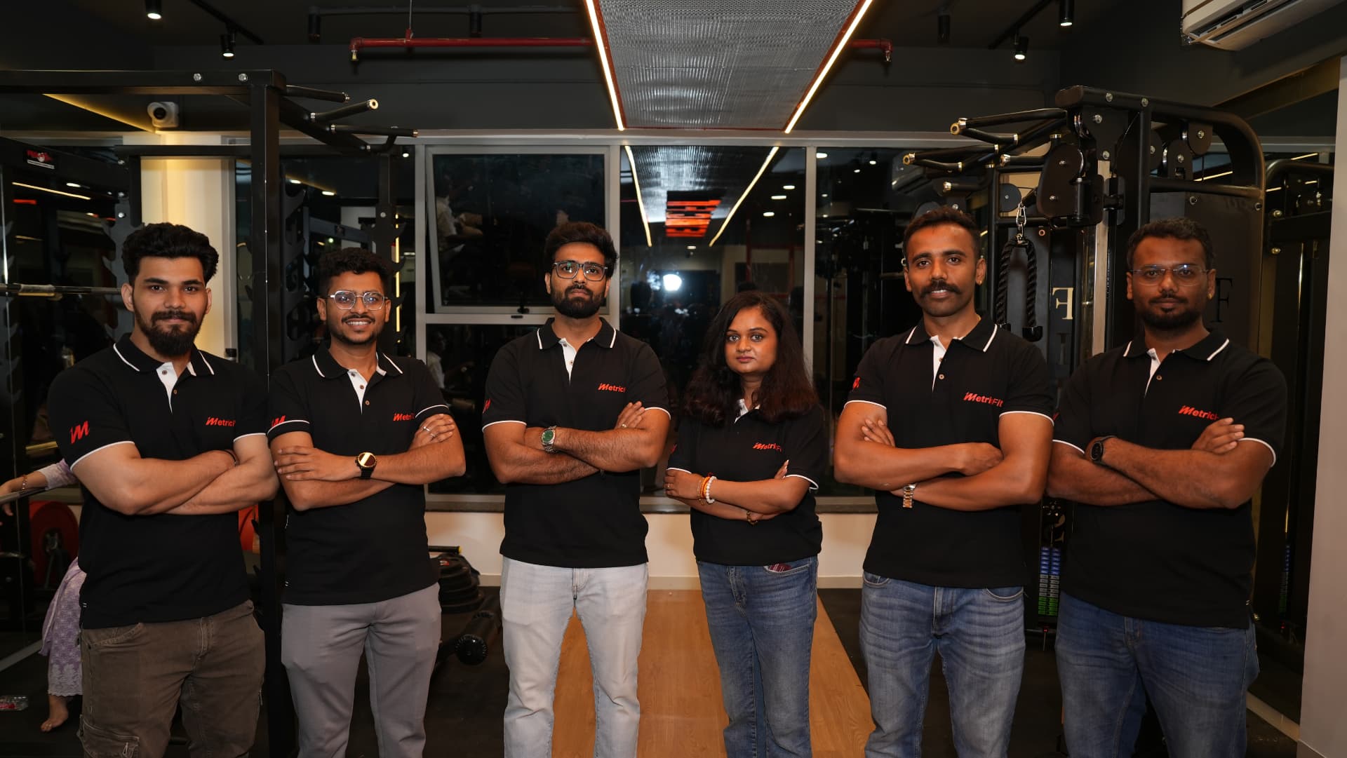 The MetricFit coaching team standing together inside the studio